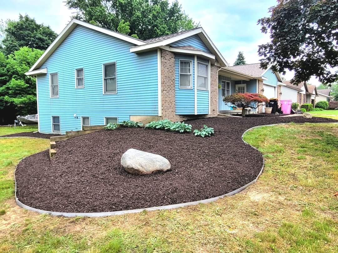 Black mulch bed with boulder accent, Grand Rapids MI