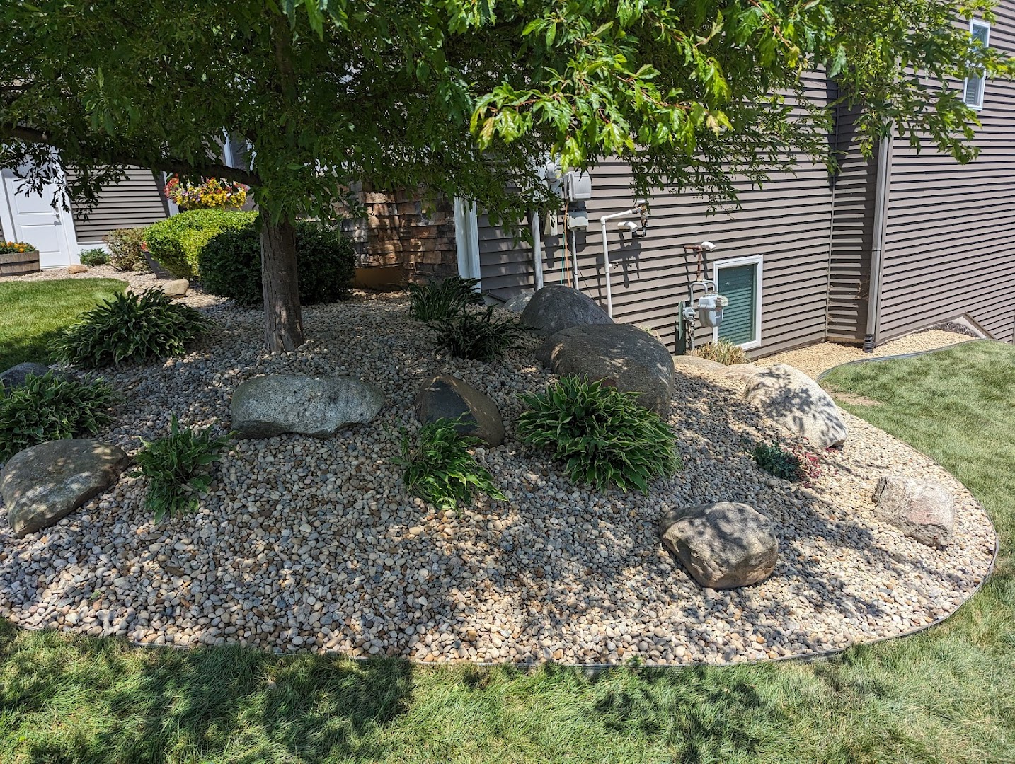 Boulder and rock landscape bed, West Michigan